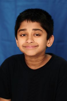 An handsome Indian kid showing happiness by miling