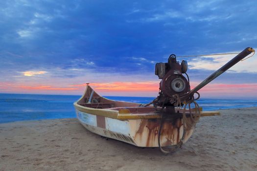 A motorized fishing boart against the morning sun