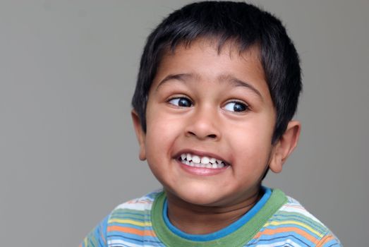 An handsome Indian kid looking very animated