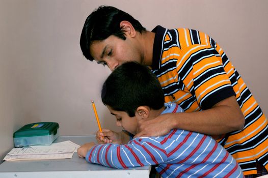Dad teaching his kid to do the homework
