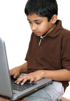 
An handsome young Indian kid working with a laptop