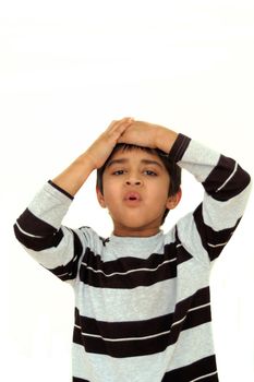 An adorable Indian kid looking very unhappy