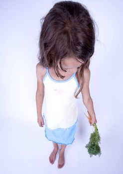 A little girl holding in her hand a beautiful flower