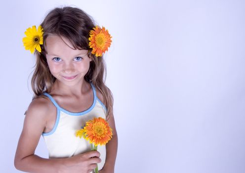 A little girl holding in her hand a beautiful flower