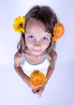 A little girl holding in her hand a beautiful flower