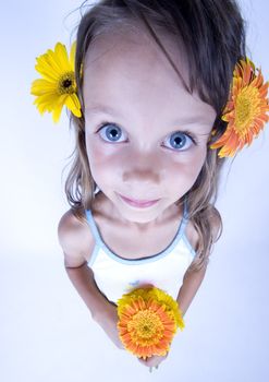 A little girl holding in her hand a beautiful flower