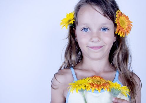 A little girl holding in her hand a beautiful flower