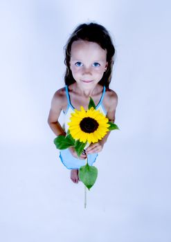 A little girl holding in her hand a beautiful flower