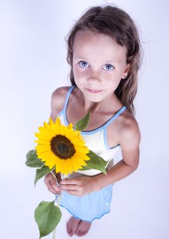 A little girl holding in her hand a beautiful flower