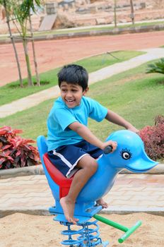 An handsome Indian kid having funat a local park