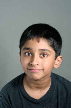 An handsome Indian kid smiling nicely for you