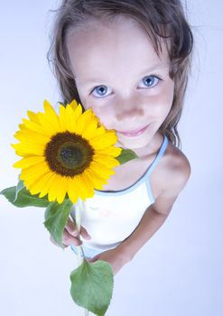 A little girl holding in her hand a beautiful flower