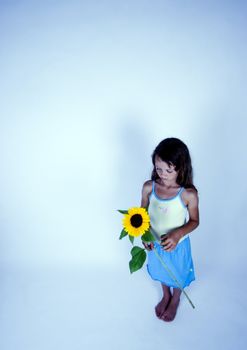 A little girl holding in her hand a beautiful flower