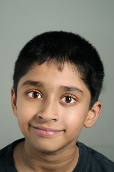 An handsome Indian kid smiling nicely for you