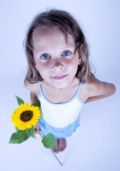 A little girl holding in her hand a beautiful flower