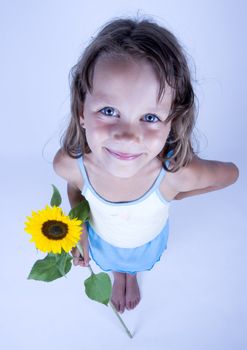 A little girl holding in her hand a beautiful flower