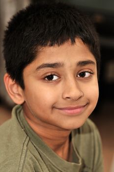 An handsome indian kid smiling for you