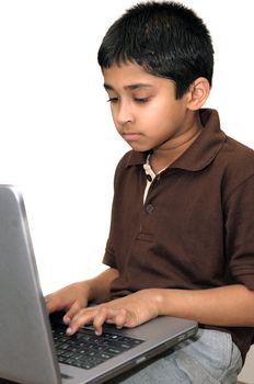 An handsome young Indian kid working with a laptop