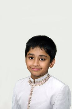 An happy and handsome Indian kid smiling before the camera