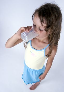 Cute girl with glass of milk