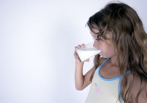 Cute girl with glass of milk