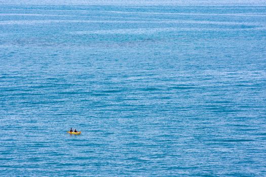 A minimalist photo of a kayak on the open ocean. Photo was taken from the coast of Bermuda.