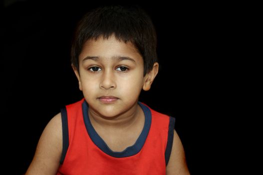 An handsome Indian kid looking very gloomy and sad