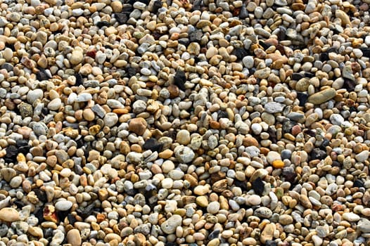 Small pebbles of different colors filling the entire frame