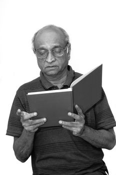 Old Indian Immigrant reading a blue book