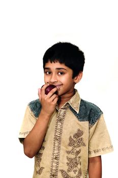 An handsome Indian kid holding apples with a smile