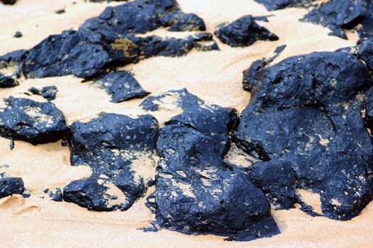 Volcanic Rocks and sand on a tropical beach