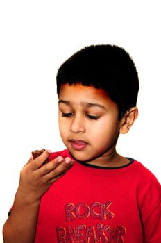 Handsome Indian child enjoying his sweet candy