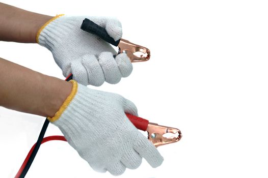 Hands and gloves with car jump start cables