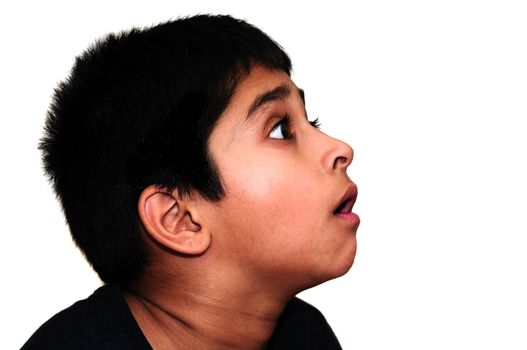 An handsome Indian kid awestruck watching television