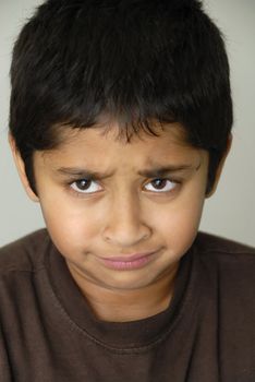 An handsome Indian kid looking very sad