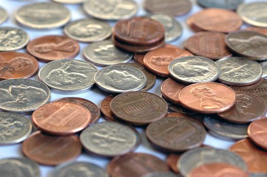 A pile of us coins on a white back ground