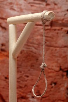 Gibbet with loop on red brick wall background