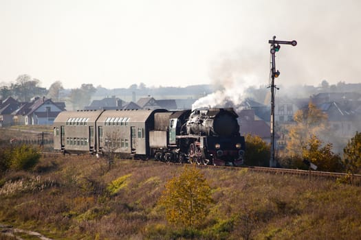 Old retro steam train passing through polish countryside
