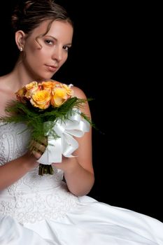 Beautiful young bride holding flowers