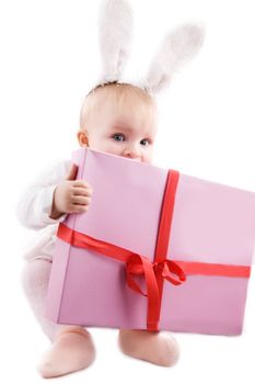 Baby in bunny costume with present on white
