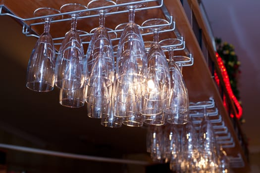 Hanging wine and champagne glasses in a bar
