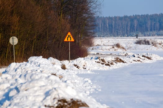 Snowy road through the countryside during wintertime

