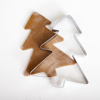 Baking homemade Gingerbread cookies with a shape of a christmas tree