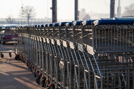 Row of empty shopping carts at the supermarket
