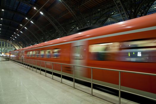 Fast train departing from the station motion blur
