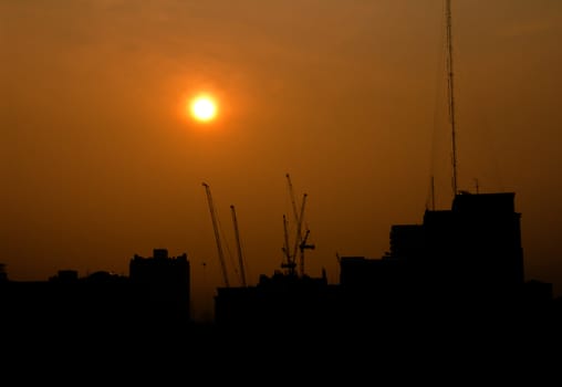 City under construction at sunrise silhouette