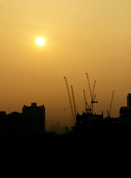 City under construction at sunrise silhouette