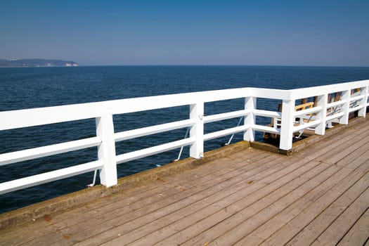 A wooden pier white barriers
