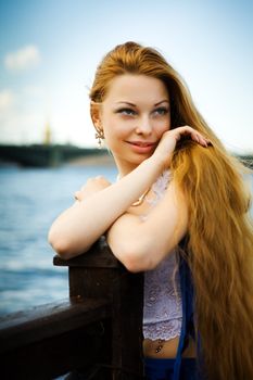 Young woman looking aside with long hair portrait