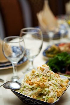 Salad closeup of full restaurant table